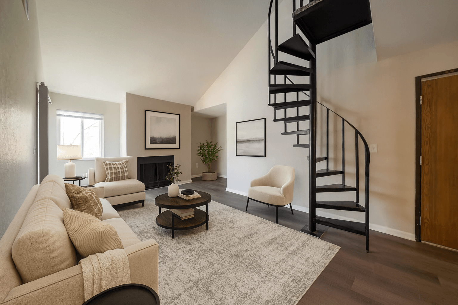 A living room with a spiral staircase and a beige couch.